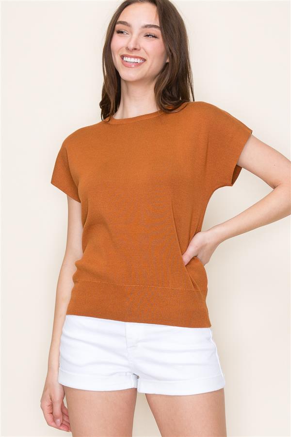 Woman wearing camel knit short sleeve sweater tee with white shorts